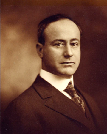 Sepia toned portrait of middle aged white man in suit.